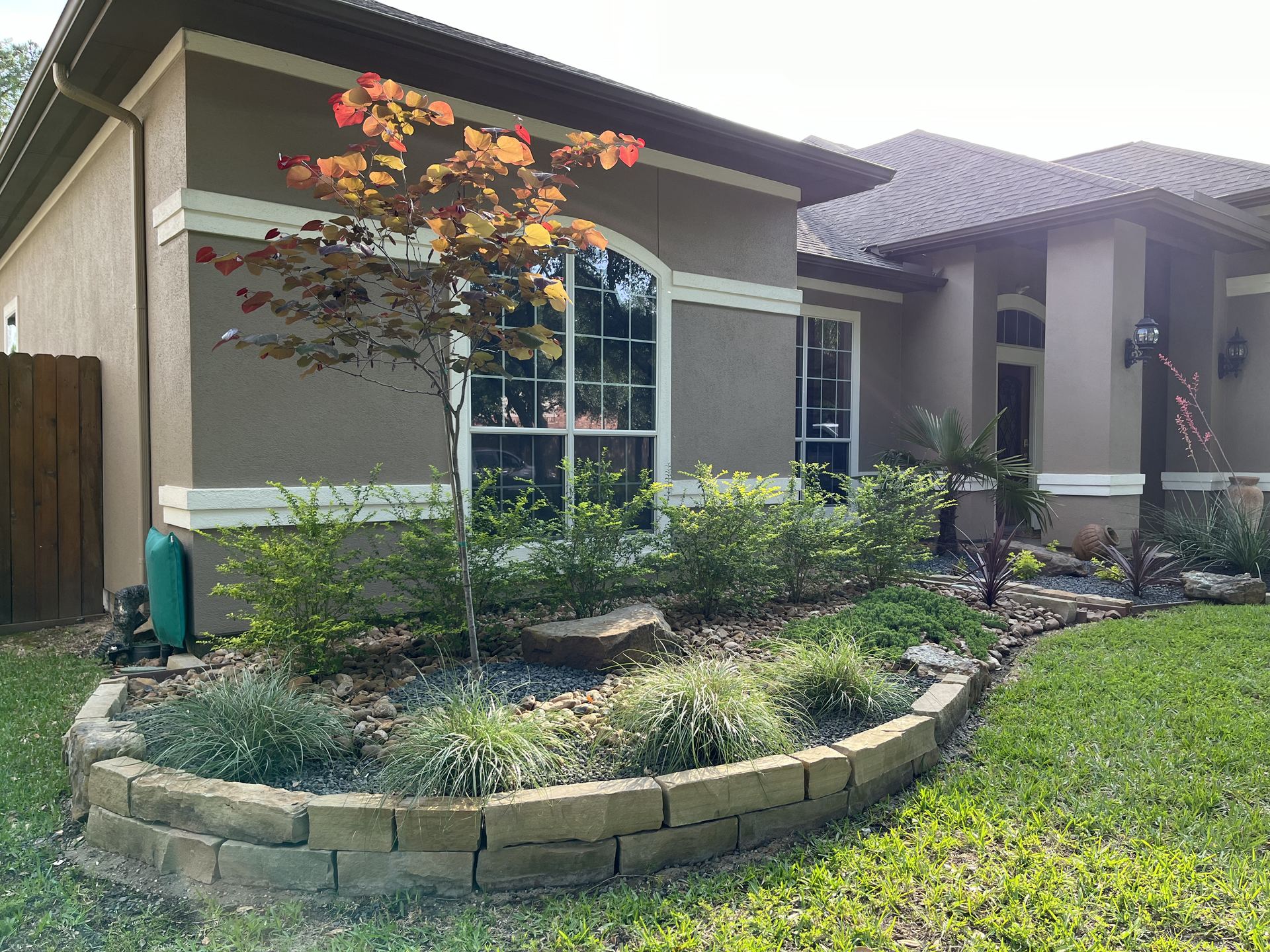 Stone-edged xeriscape planting bed Houston TX