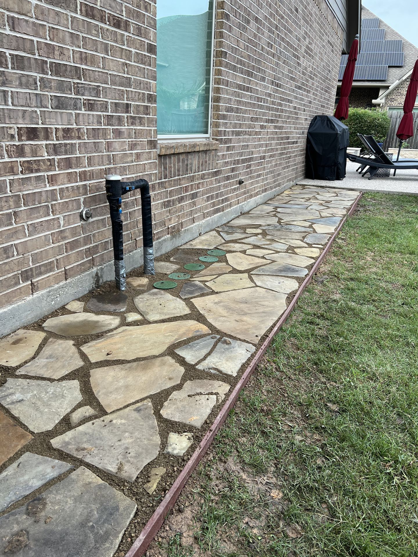 Flagstone side walkway installation Houston TX