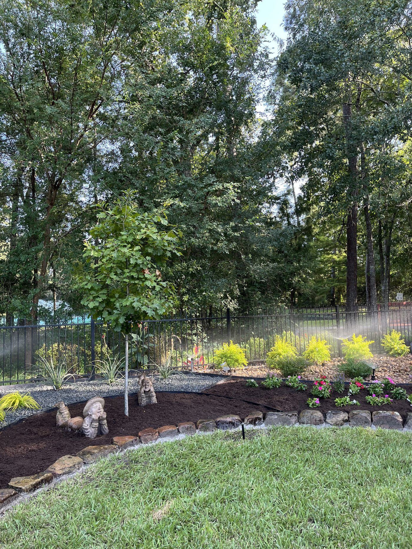 Landscape bed with irrigation and stone border Houston TX