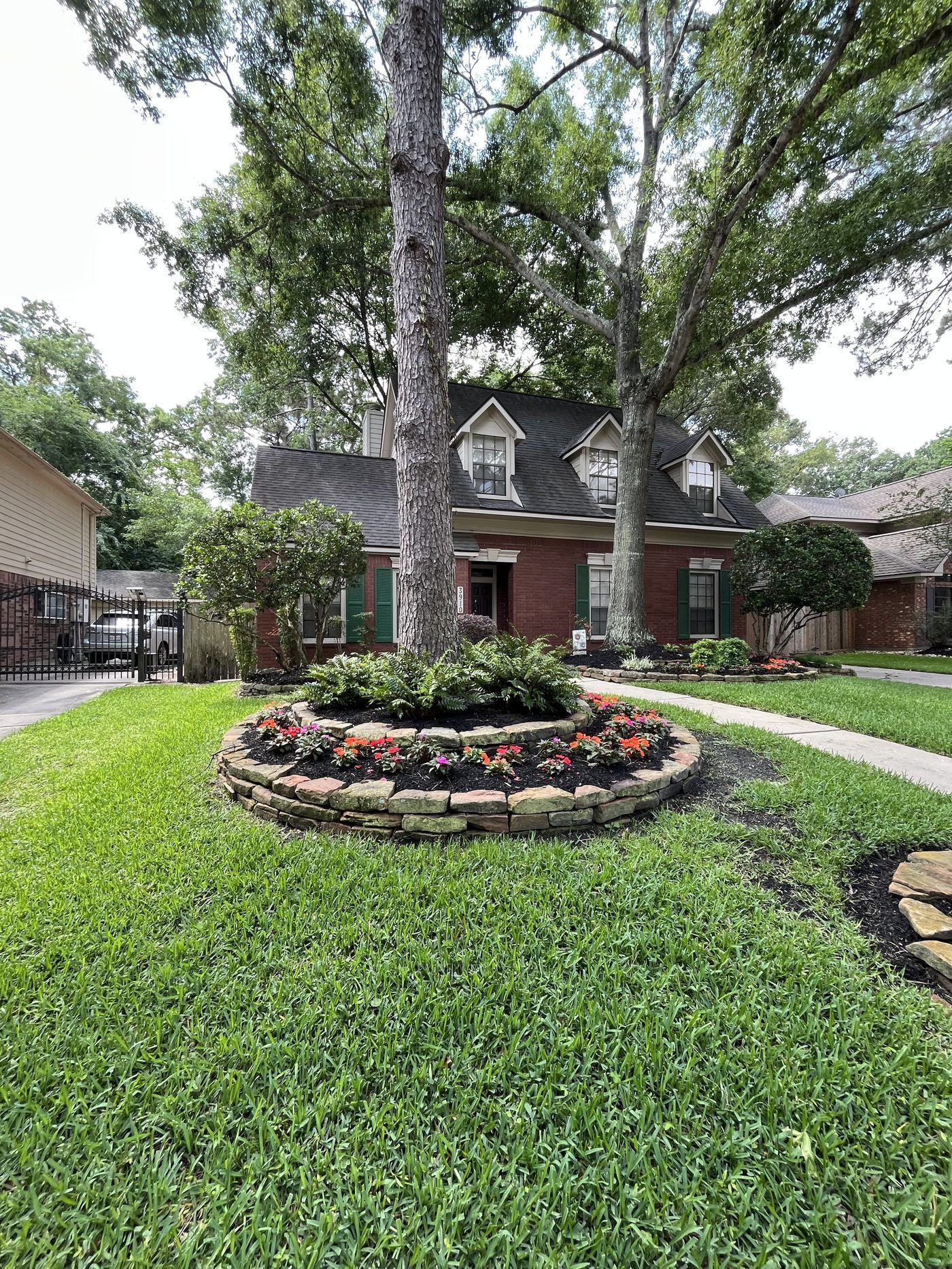 Front yard circular flower bed around tree Houston TX