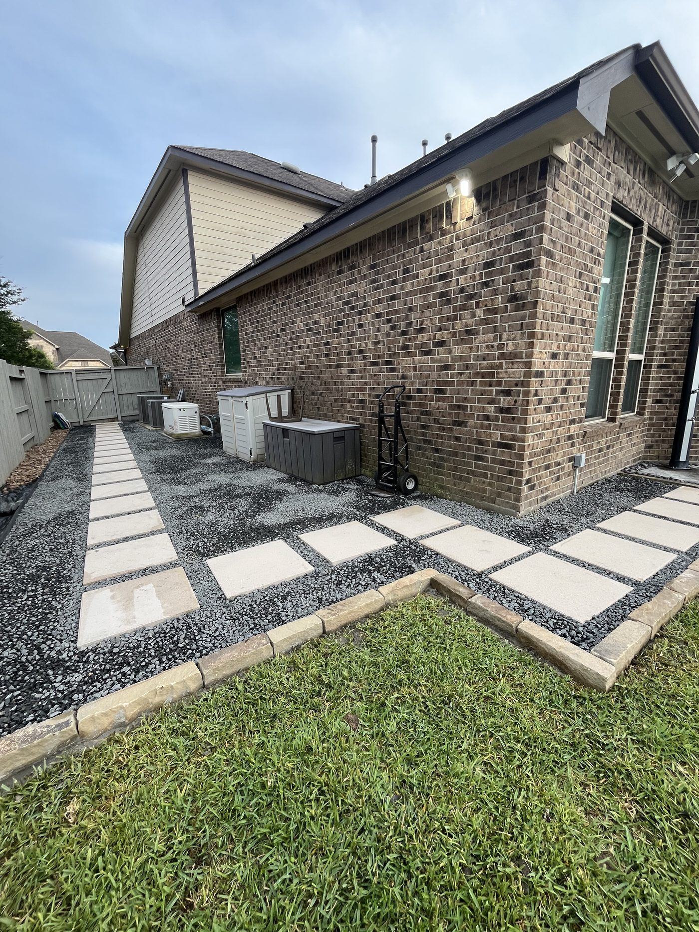 Stepping stone side yard path with gravel Houston TX