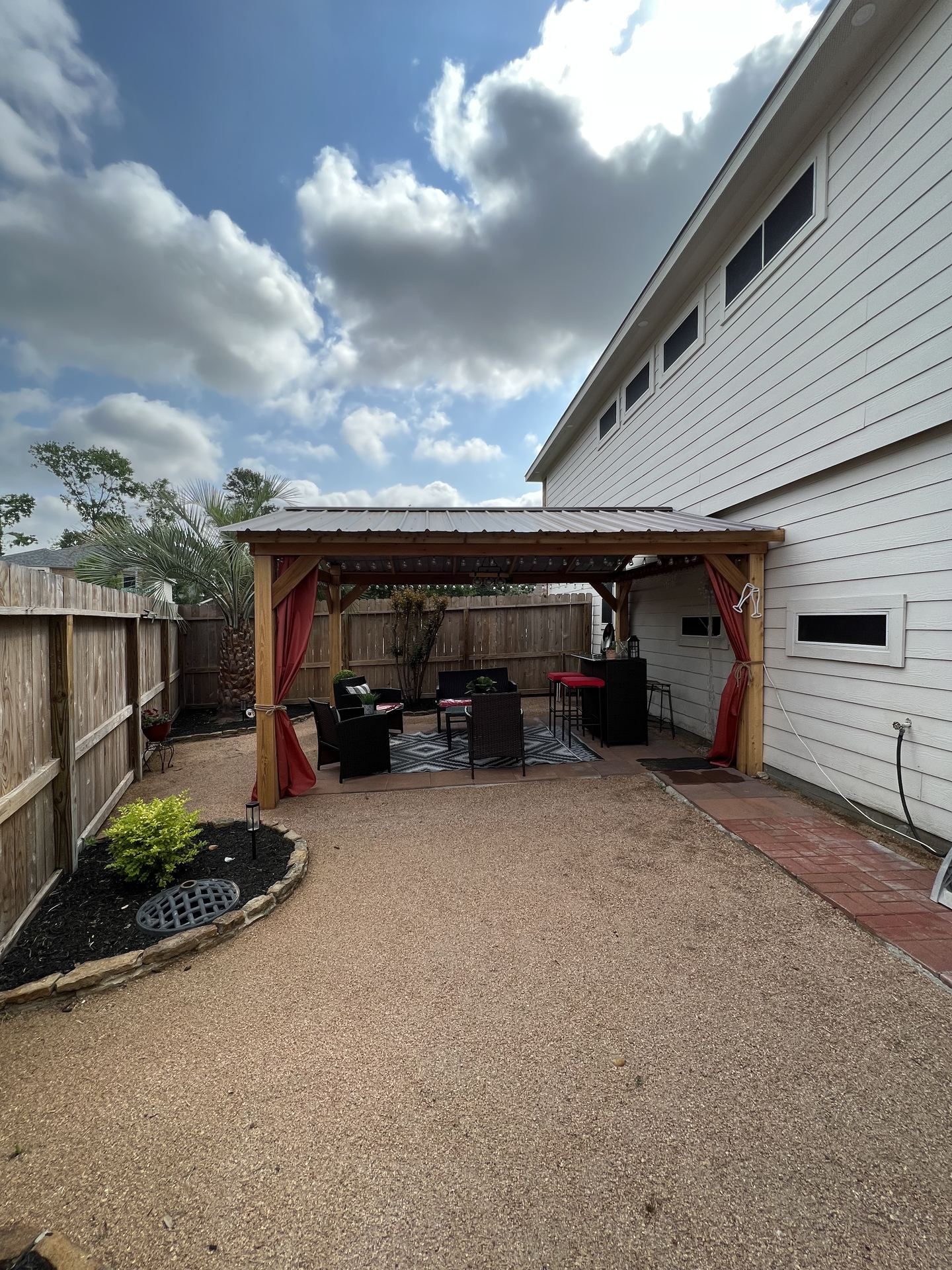 Cedar pergola with metal roof over patio Houston TX